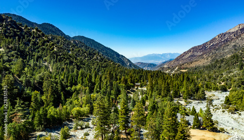 Aerial view of Forest Falls and Oak Creek in the San bernardino Mountains and National Forest with blue sky, green and yellow trees and plants photo