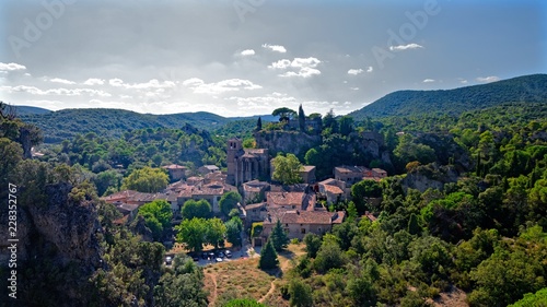Village surrounded by hills and forest in southern France