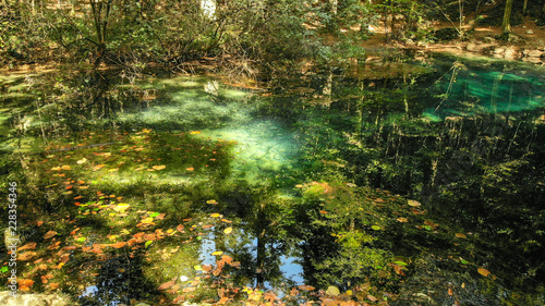 Fototapeta Naklejka Na Ścianę i Meble -  Beautiful pond in the forest Lacul Ochiul Beiului, Romania. National park Nerei beusnita. Autumn with beautiful colors.