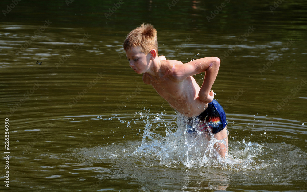 Fototapeta premium The boy is bathing on the river.