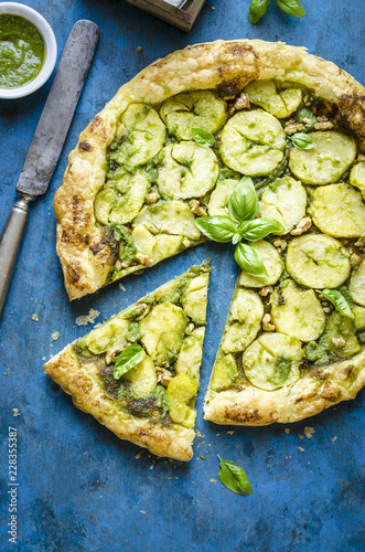 Overhead view of potato and walnut pesto tart on table photo