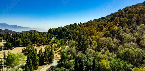 Aerial, drone view of Oak Glen located between the San Bernardino Mountains and Little San Bernardino Mountains with several apple orchards before the Fall color change photo