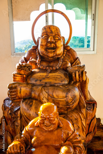 Phra sangkatchai monk statue made from wood in Hyuaplakang temple photo