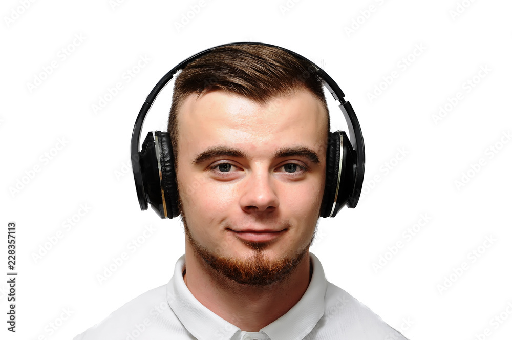 Young man with beard on headphones, good mood. Isolated white background. Young man with beard on headphones, good mood. Isolated white background.
