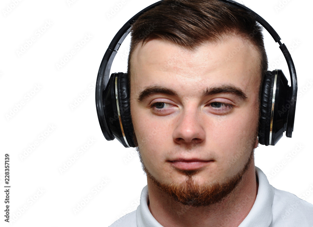 Young man with beard on headphones, good mood. Isolated white background.