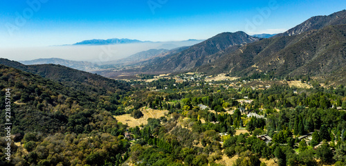 Aerial  drone view of Oak Glen located between the San Bernardino Mountains and Little San Bernardino Mountains with several apple orchards before the Fall color change