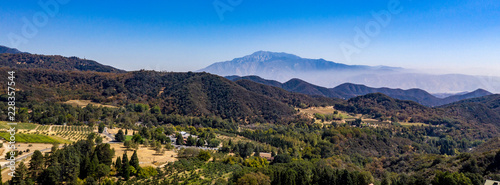 Aerial, drone view of Oak Glen located between the San Bernardino Mountains and Little San Bernardino Mountains with several apple orchards before the Fall color change