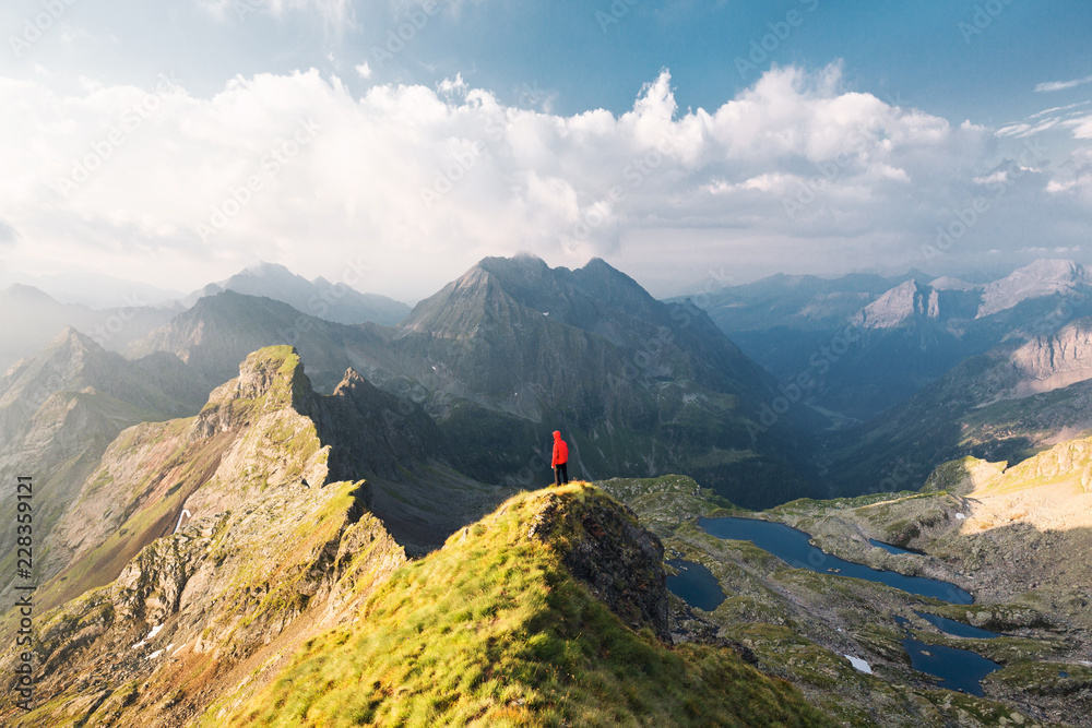 Person standing on top of a mountain Person standing on top of a mountain