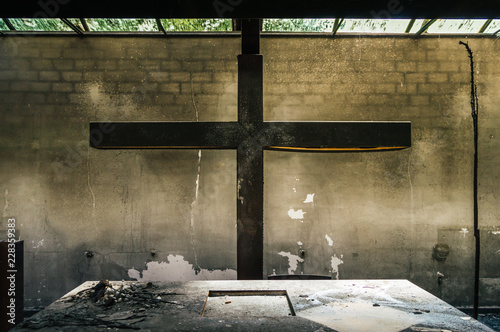 Foto Altar and huge cross in a church or chapel destroyed by fire of a candle