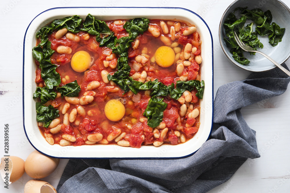 Shakshuka in a baking dish with silverbeet. Shakshuka in a baking dish with silverbeet.