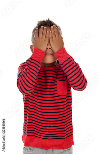 Small latin child covering their eyes