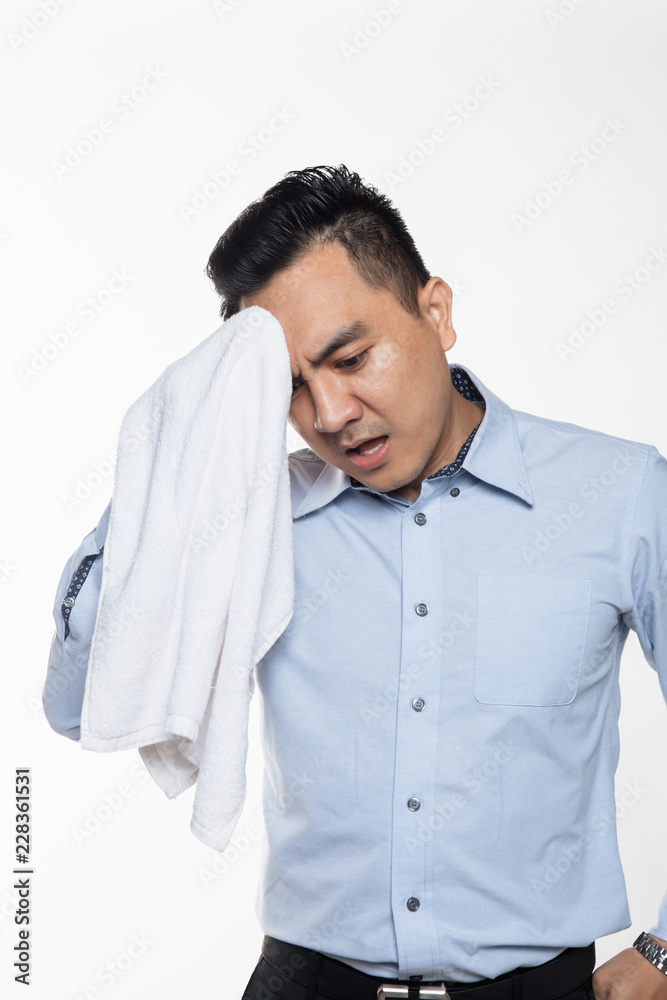 Asian man with work attire feeling exhausted and sweaty Asian man with work attire feeling exhausted and sweaty