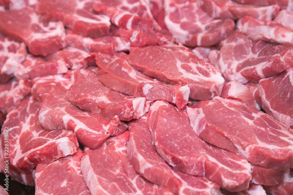 Fresh raw pork chops at butcher shop