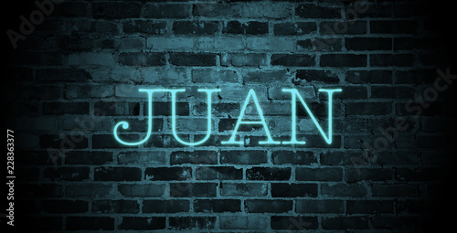 first name Juan in blue neon on brick wall © christopher-oliver