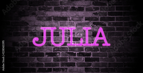 first name Julia in pink neon on brick wall photo