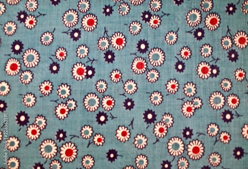 Fragment of colorful retro tapestry text. Fabric striped, flowered texture.