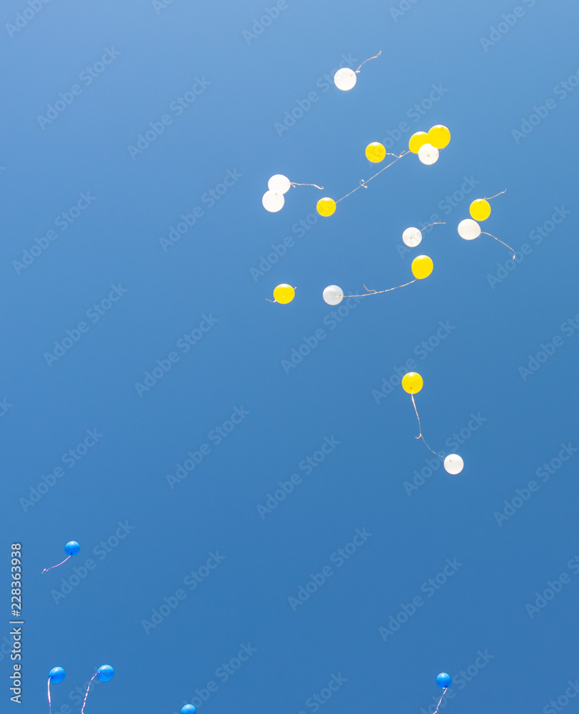 air multicolored balls in the blue sky. Helium balls - red, blue, white, colorful balls flying against the blue air multicolored balls in the blue sky. Helium balls - red, blue, white, colorful balls flying against the blue