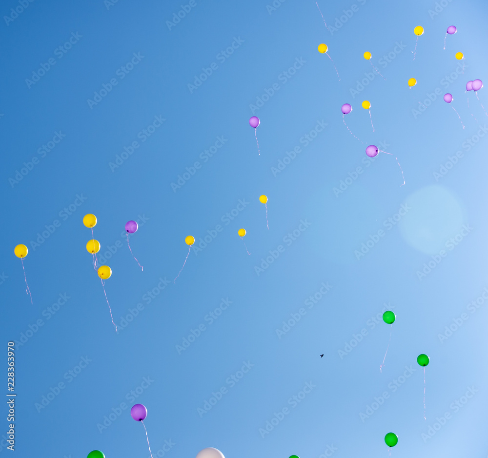 air multicolored balls in the blue sky. Helium balls - red, blue, white, colorful balls flying against the blue air multicolored balls in the blue sky. Helium balls - red, blue, white, colorful balls flying against the blue