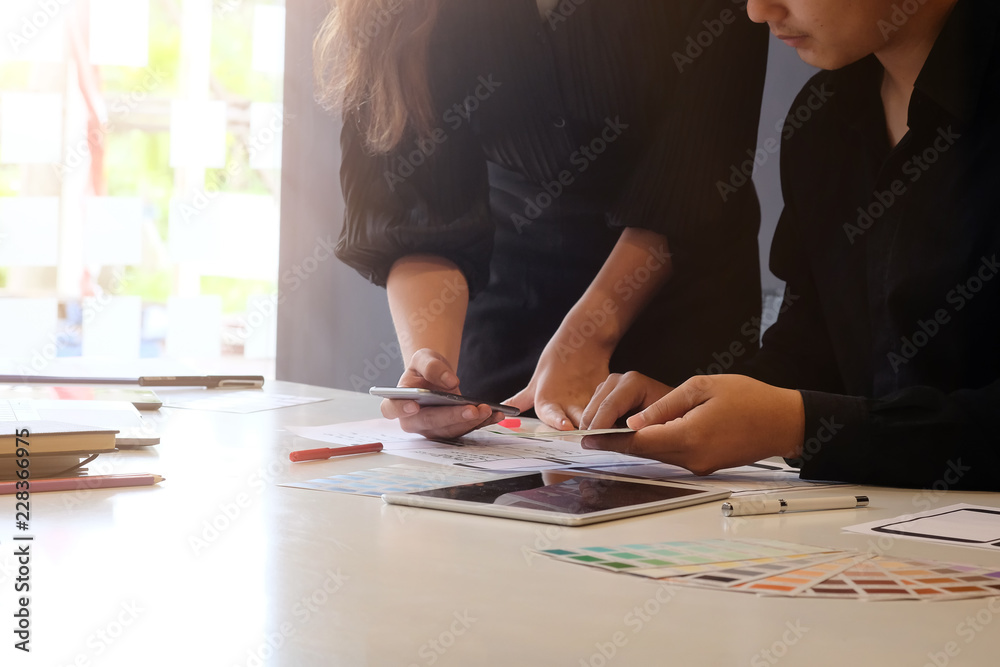 Designer team of mobile technology UX UI working on paper and tablet. Designer team of mobile technology UX UI working on paper and tablet.