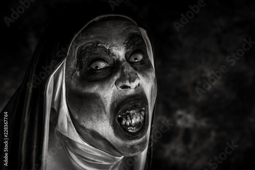 Fotografie frightening evil nun with bloody teeth.