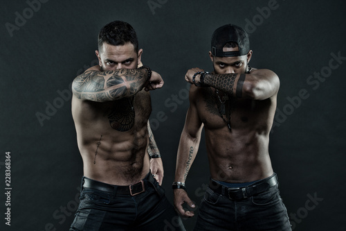 Sexy and confident. Brutal macho style. Muscular men with fashionable tattoo style. Sexy men with muscular torso. Tattoo is like a timeline of the life, vintage filter