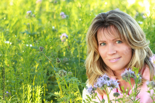 Face of an attractive mature woman in a lilac flowerfield