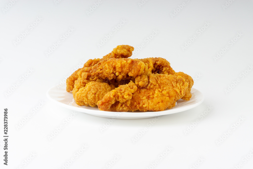 Fried breaded chicken fillet isolated on white background with selective focus and crop fragment