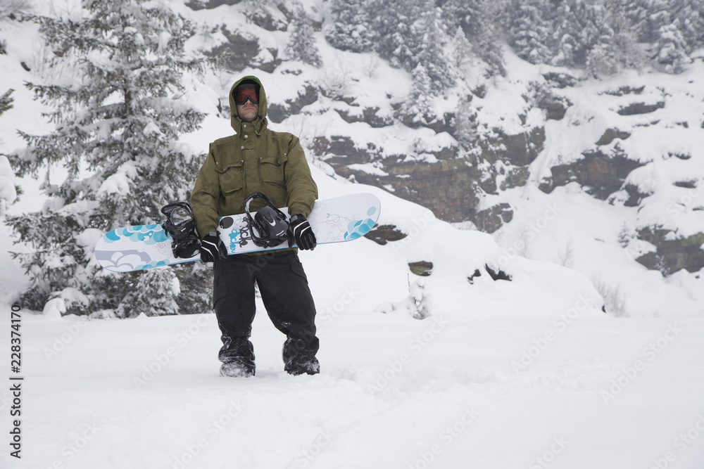 Snowboarder with snowboard clothes in the snow powder