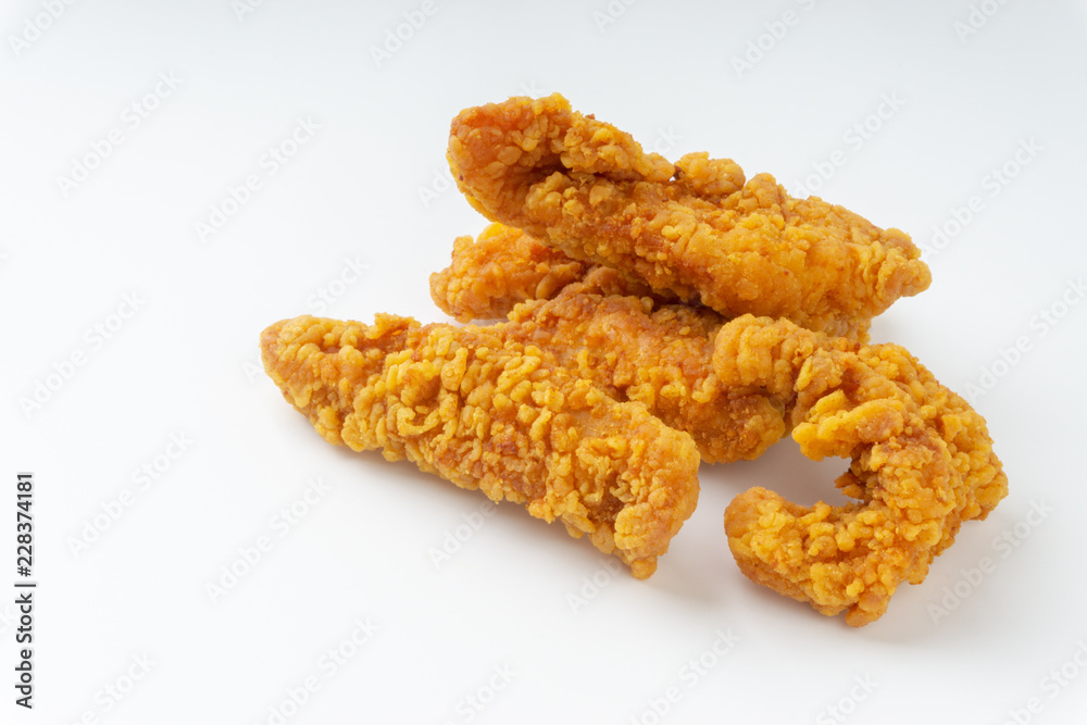 Fried breaded chicken fillet isolated on white background with selective focus and crop fragment Fried breaded chicken fillet isolated on white background with selective focus and crop fragment
