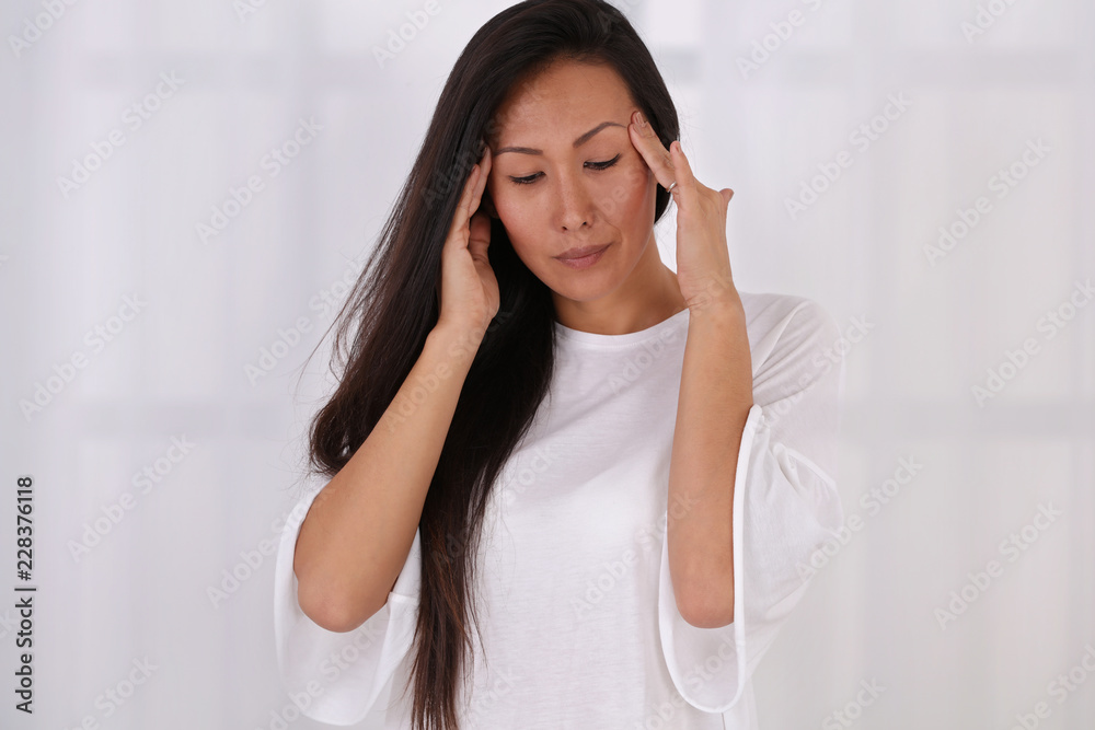 Asian Woman suffering from headache, migraine Asian Woman suffering from headache, migraine