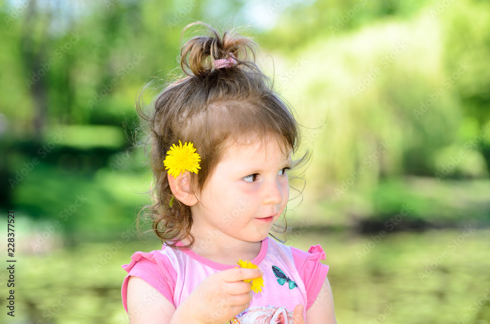 Portrait of a small three year old caucasian girl in a park Portrait of a small three year old caucasian girl in a park
