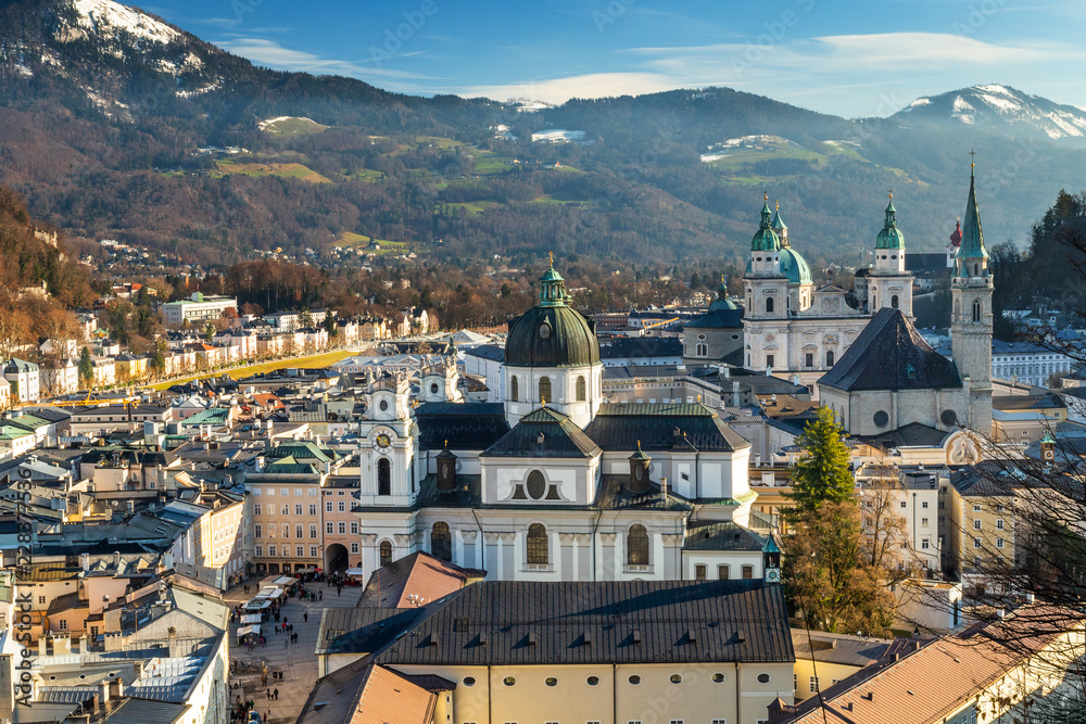 Postcard view on Salzburg city with Cathedral and Kollegienkirche church, Austria in winter