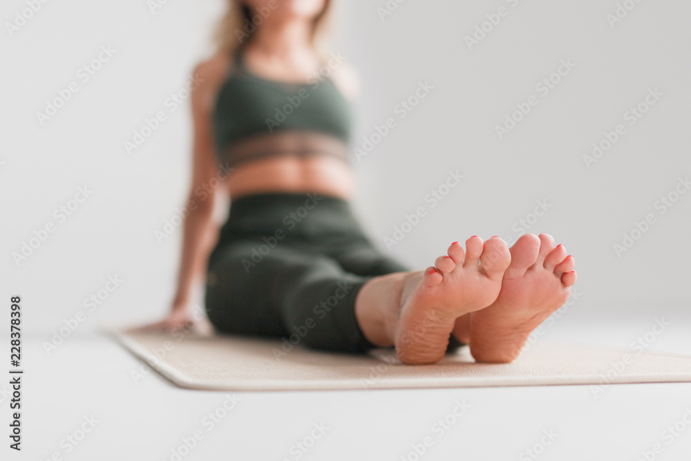 Blurred female sitting on yoga mat