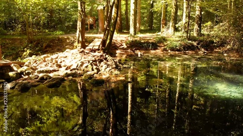 Beautiful pond in the forest Lacul Ochiul Beiului, Romania. National park Nerei beusnita. Autumn with beautiful colors.