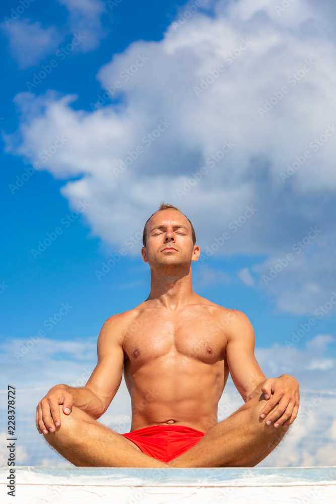 Handsome Shirtless Young Man During Meditation or Doing an Outdoor
