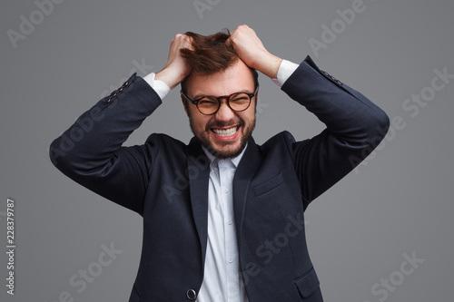 Angry businessman tearing hair out photo