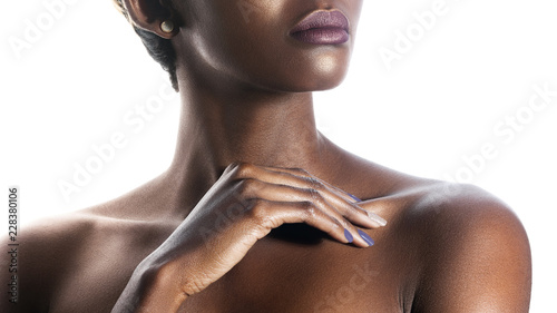 Palm and lips of young beautiful black woman with clean perfect skin close-up