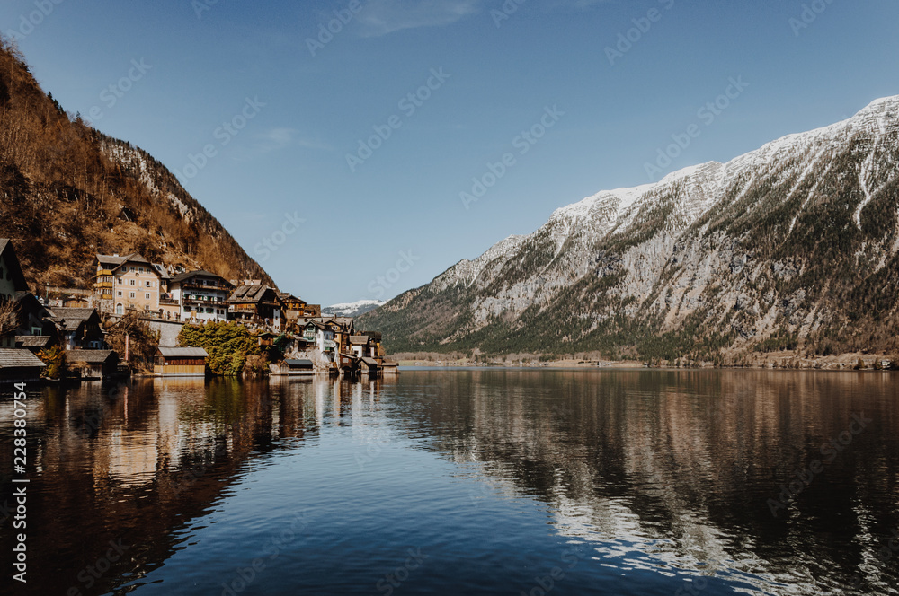 Spectacular view on Hallstatt village reflecting in mountain lake