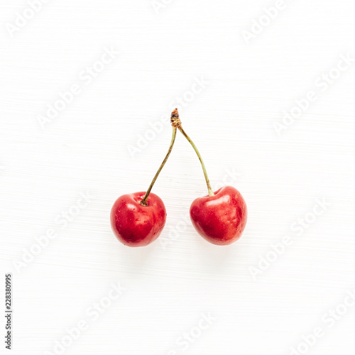 Cherries branch isolated on white background. Flat lay, top view minimal food concept.