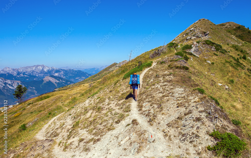Tourist on the mountain trail, Beautiful summer landscape on background