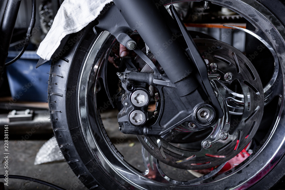 Cropped close up shot of beautiful and custom made motorcycle in the workshop Cropped close up shot of beautiful and custom made motorcycle in the workshop