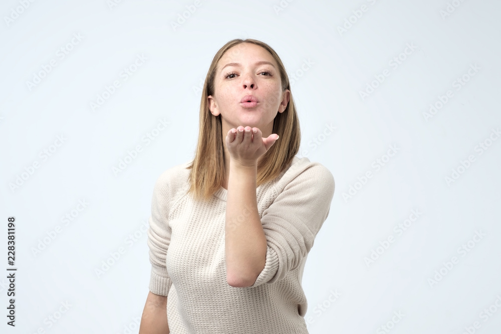 Portrait of young beautiful woman sending an air kiss Portrait of young beautiful woman sending an air kiss