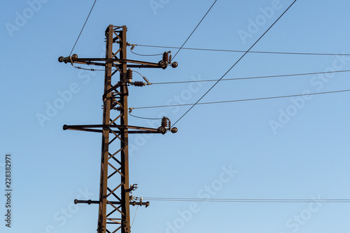 Electric column and wires of high voltage on blue sky background