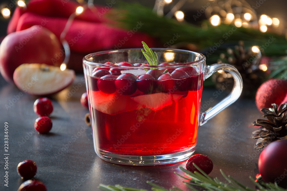 Christmas cranberry and apple drink garnish rosemary and fir branches on black. Close up. Xmas drink. Christmas cranberry and apple drink garnish rosemary and fir branches on black. Close up. Xmas drink.