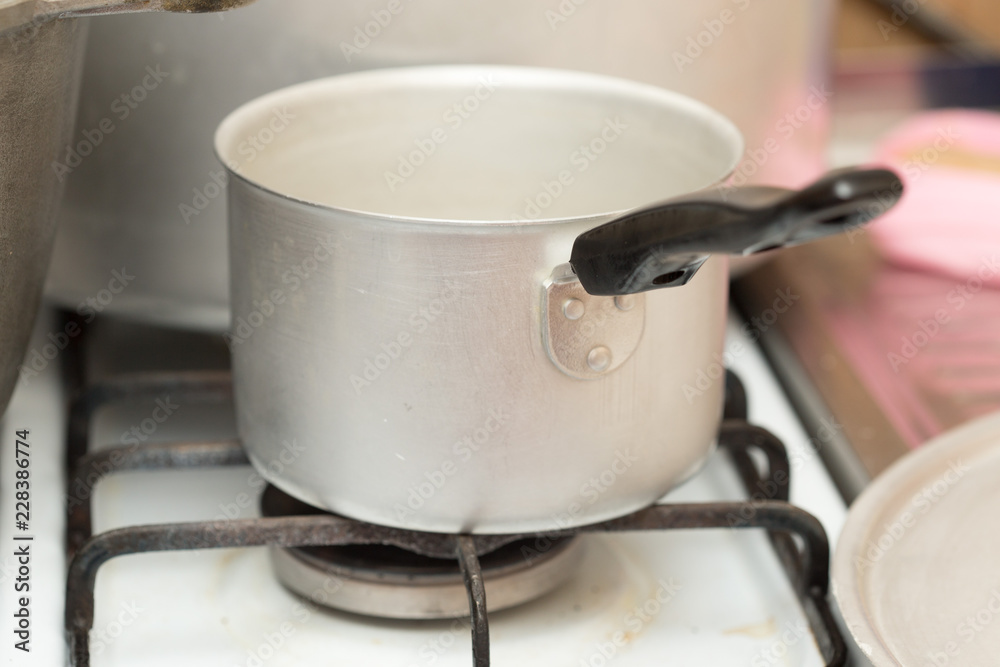 A pot on a gas cooker A pot on a gas cooker
