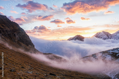 Great view of the foggy valley in Gran Paradiso National Park   Alps  Italy   dramatic scene  beautiful world. colourful autumn morning scenic view with cloudy sky  majestic dawn in mountain landscape
