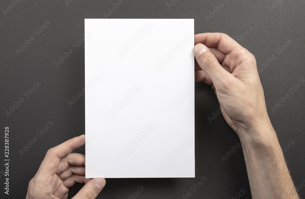Mens hands holding white letterhead Mens hands holding white letterhead
