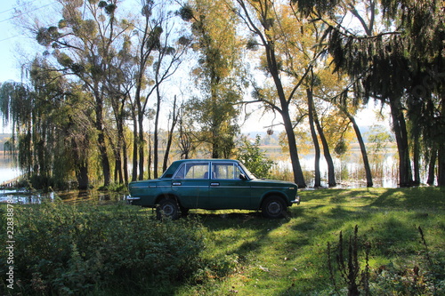 green soviet car near the lake