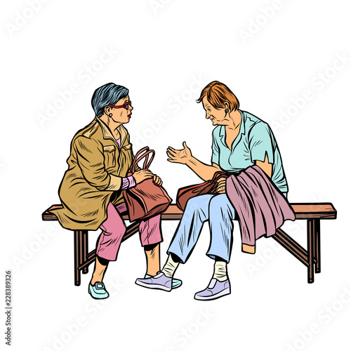 two elderly women sitting on a bench