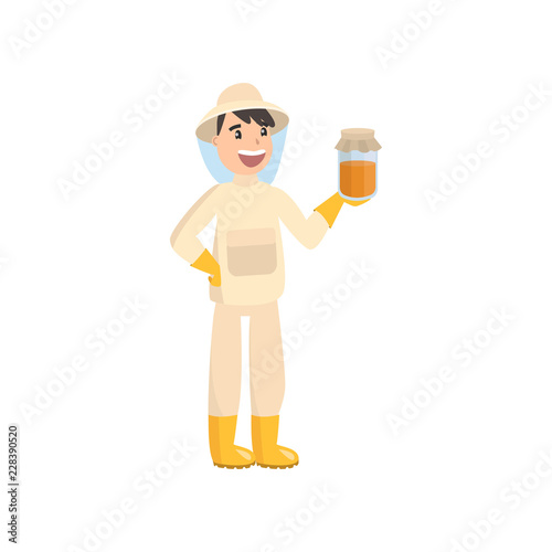 Beekeeper collects honey from bees. Beekeeper in a bee protection suit with a jar of honey.